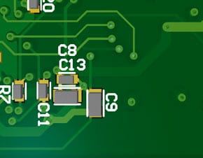 Cluster of capacitors supporting a regulator on the opposite side. Positions have been optimized for best decoupling performance over reflow profile.